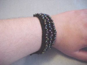 Black Beaded Strap on wrist.